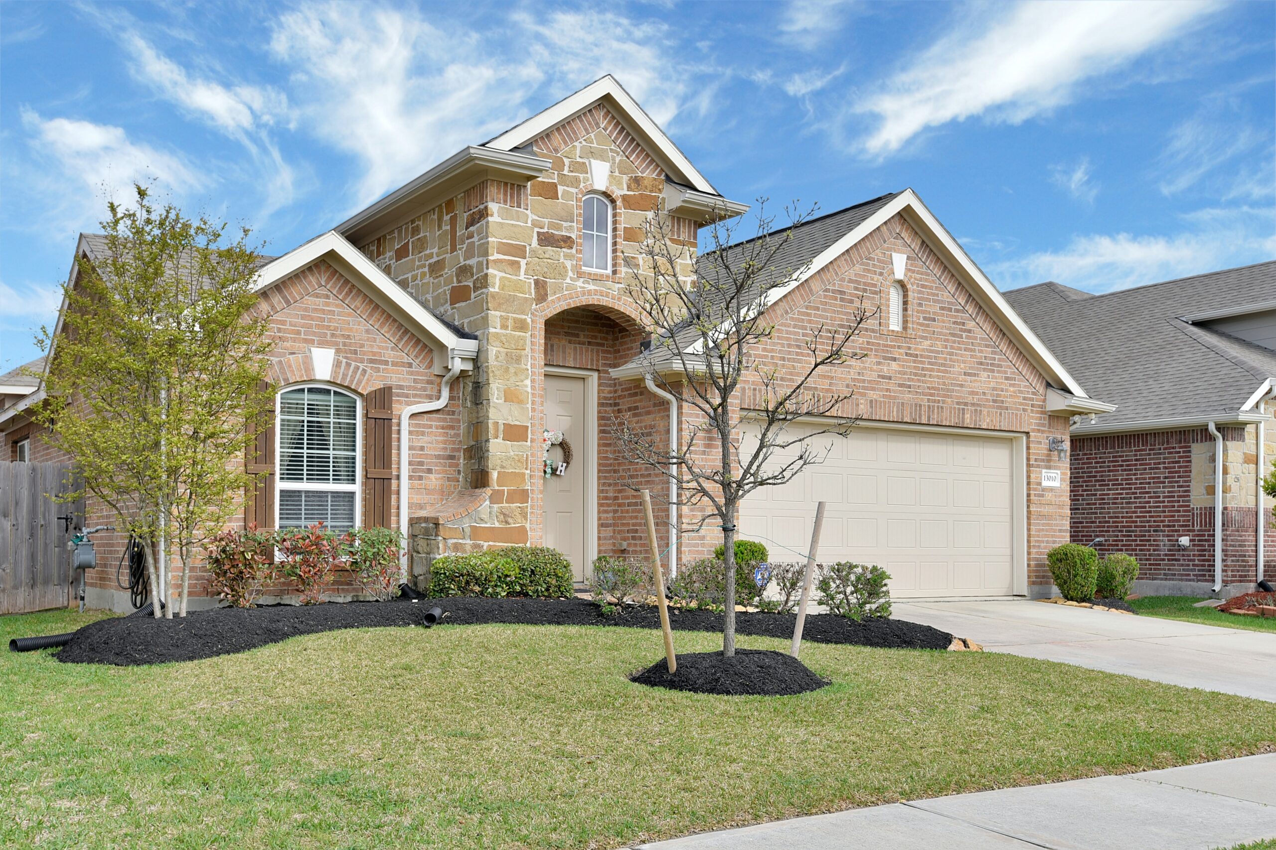 Suburban brick house with garage and lawn